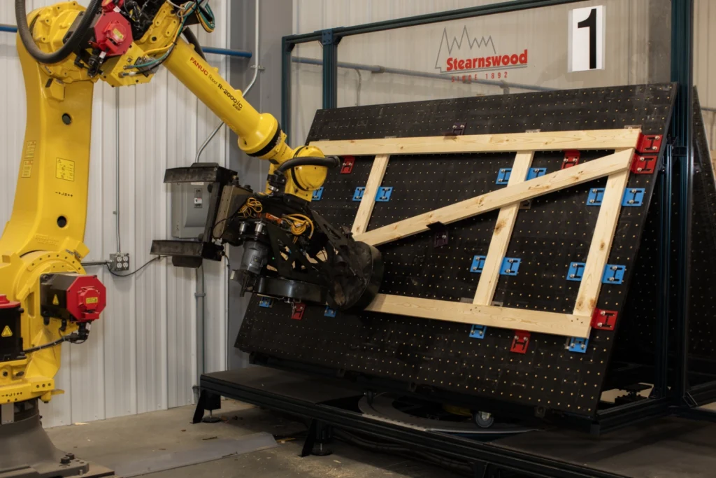 robot arm drilling a custom wood frame for packaging