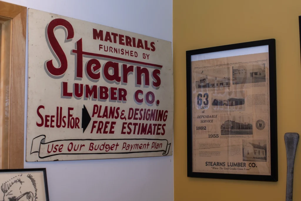 old stearns lumber company sign and framed newspaper clippings in the stearnswood museum